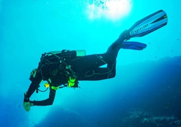 Instructor scuba diving underwater